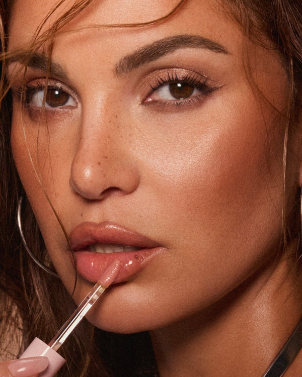 Close up of Negin Mirsalehi applying Lip Oil.
