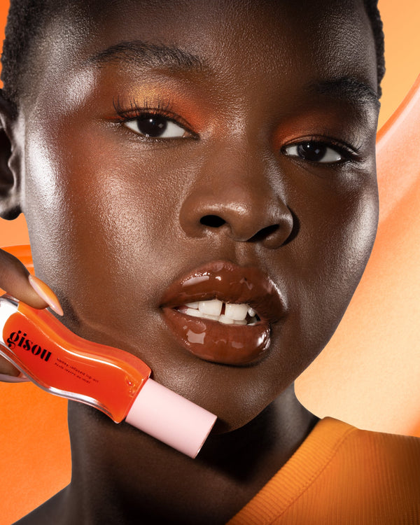 Model holding the mango lip oil.