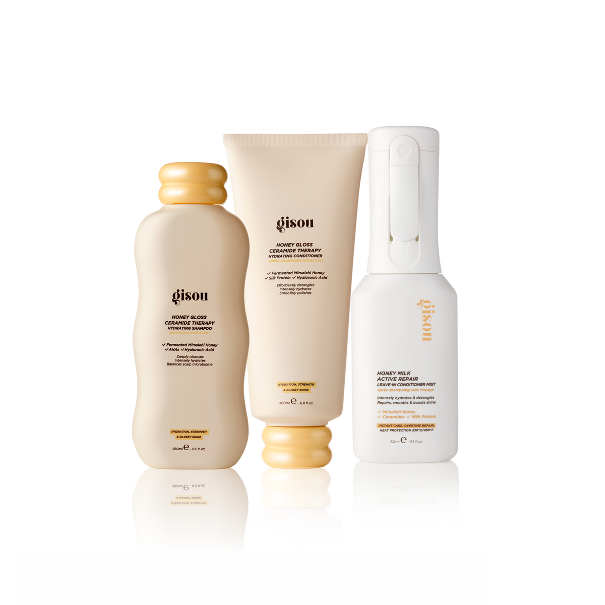 Gisou Honey Glow Haircare Trio: shampoo, conditioner and leave-in conditioner mist on a white background.