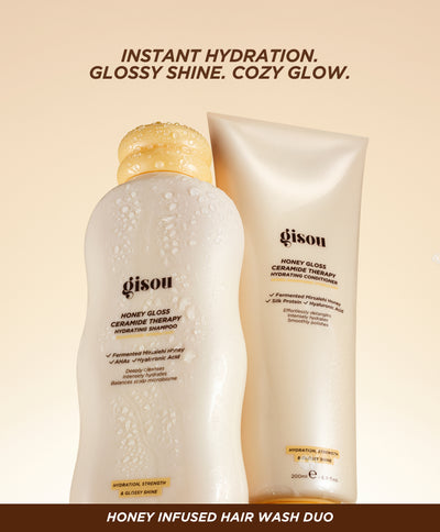 Gisou Honey Gloss Ceramide Therapy Hydrating Shampoo and Conditioner displayed on a yellow background, highlighting instant hydration, glossy shine and cozy glow.