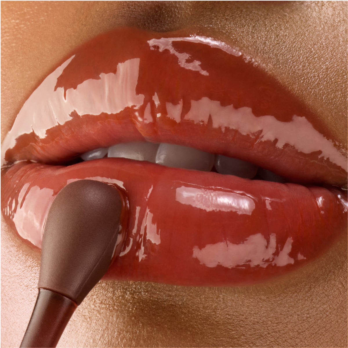 Close-up of a lip mask wand applying mask to lips.