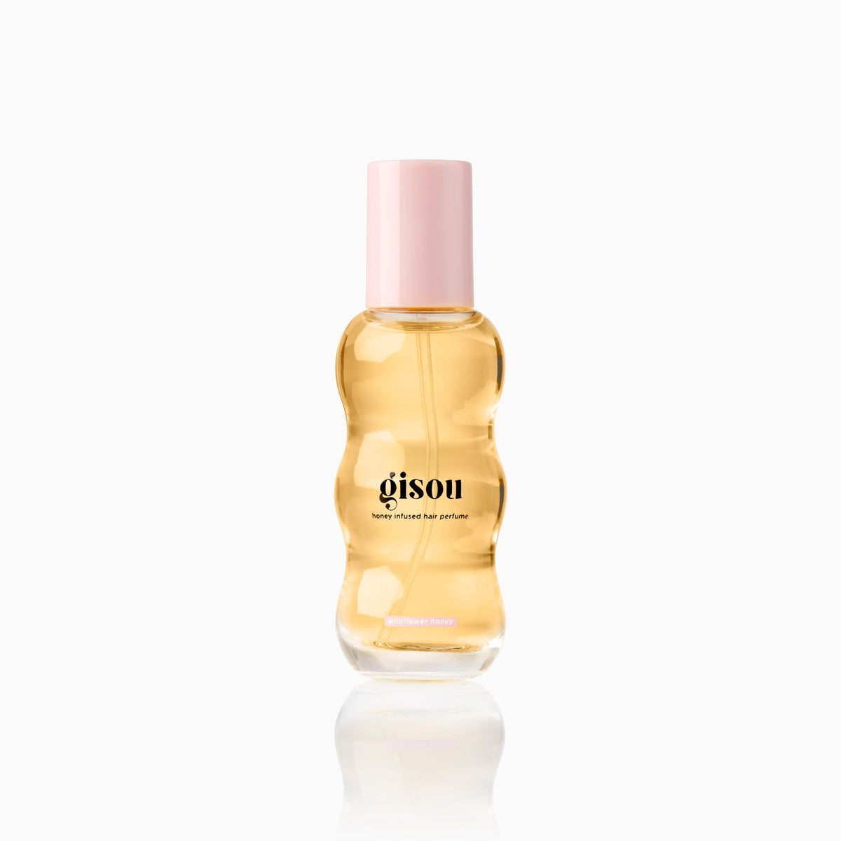 Mini hair perfume bottle 0.5fl with light pink cap in Wildflower Honey scent on a white background.