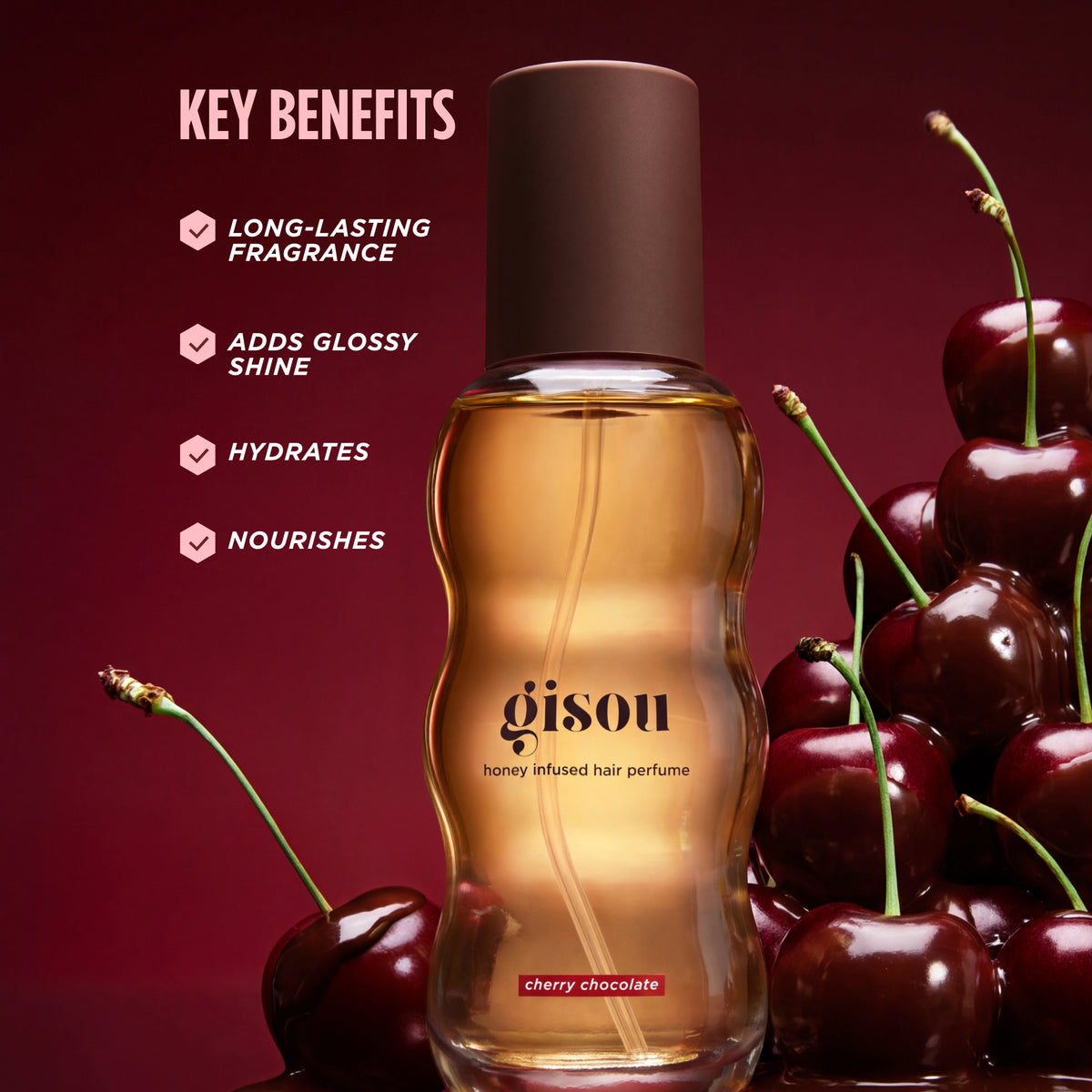 Gisou Cherry Chocolate hair perfume bottle surrounded by cherries on a dark red background, listing key benefits.