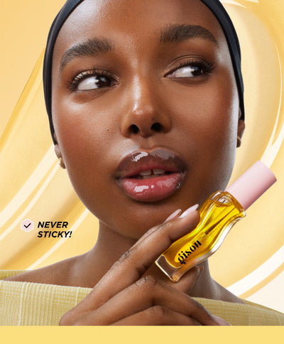 Model holding the lip oil bottle.