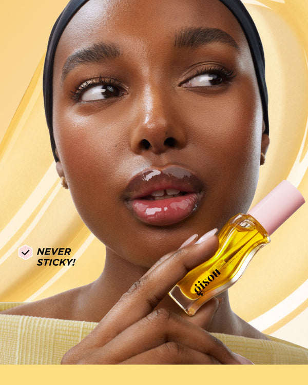Model holding the lip oil bottle.
