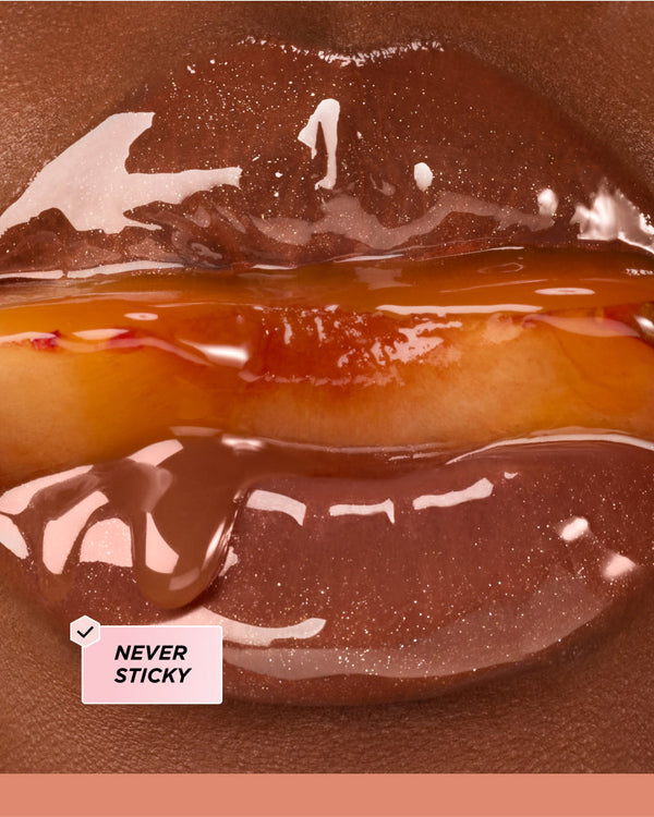 Close up of lips surrounding a peach.