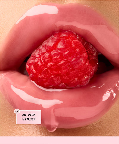 Lips surrounding a raspberry.