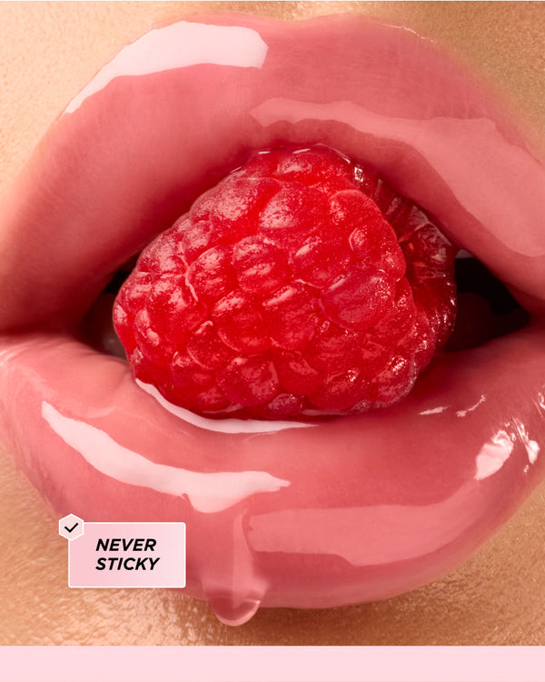 Lips surrounding a raspberry.