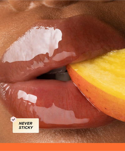 Close up of lips biting a mango.