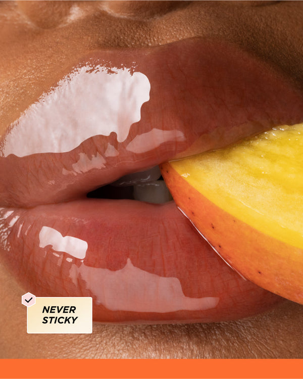 Close up of lips biting a mango.