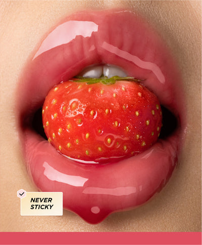 Lips surrounding a strawberry.