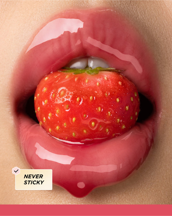 Lips surrounding a strawberry.
