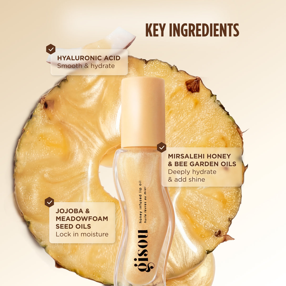 Pineapple Pout lip oil bottle placed in front of a pineapple slice, with ingredient callouts for hyaluronic acid, Mirsalehi honey and bee garden oils, and jojoba and meadowfoam seed oils.