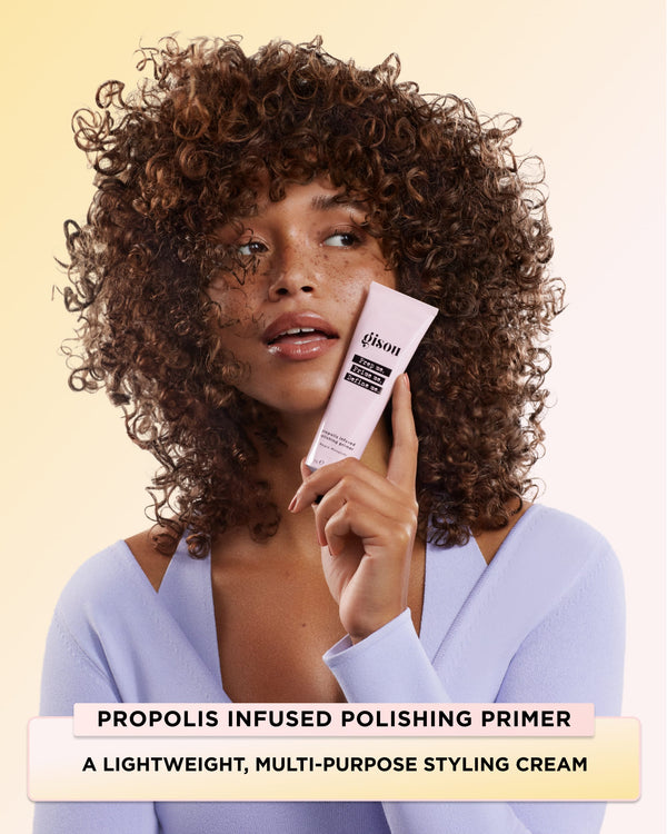 A model holding Propolis Infused Polishing Primer 
