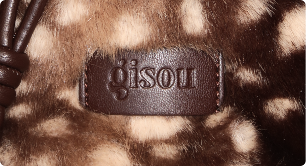 Embossed Gisou leather tag on fawn-print faux fur