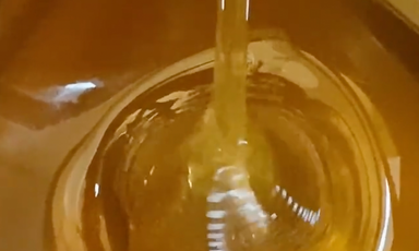 Honey being poured and forming a pile of honey