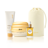 Gisou Honey Milk 5-in-1 Styling Cream, Honey Gloss Ceramide Therapy Hair Mask, Honey Infused Hair Oil, and a Gisou Honey Glow Hair Towel pouch grouped together on white.
