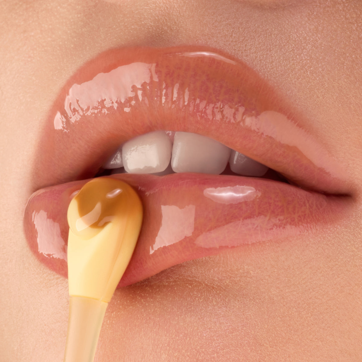 Close-up of lips applying Gisou Crème Brûlée lip mask