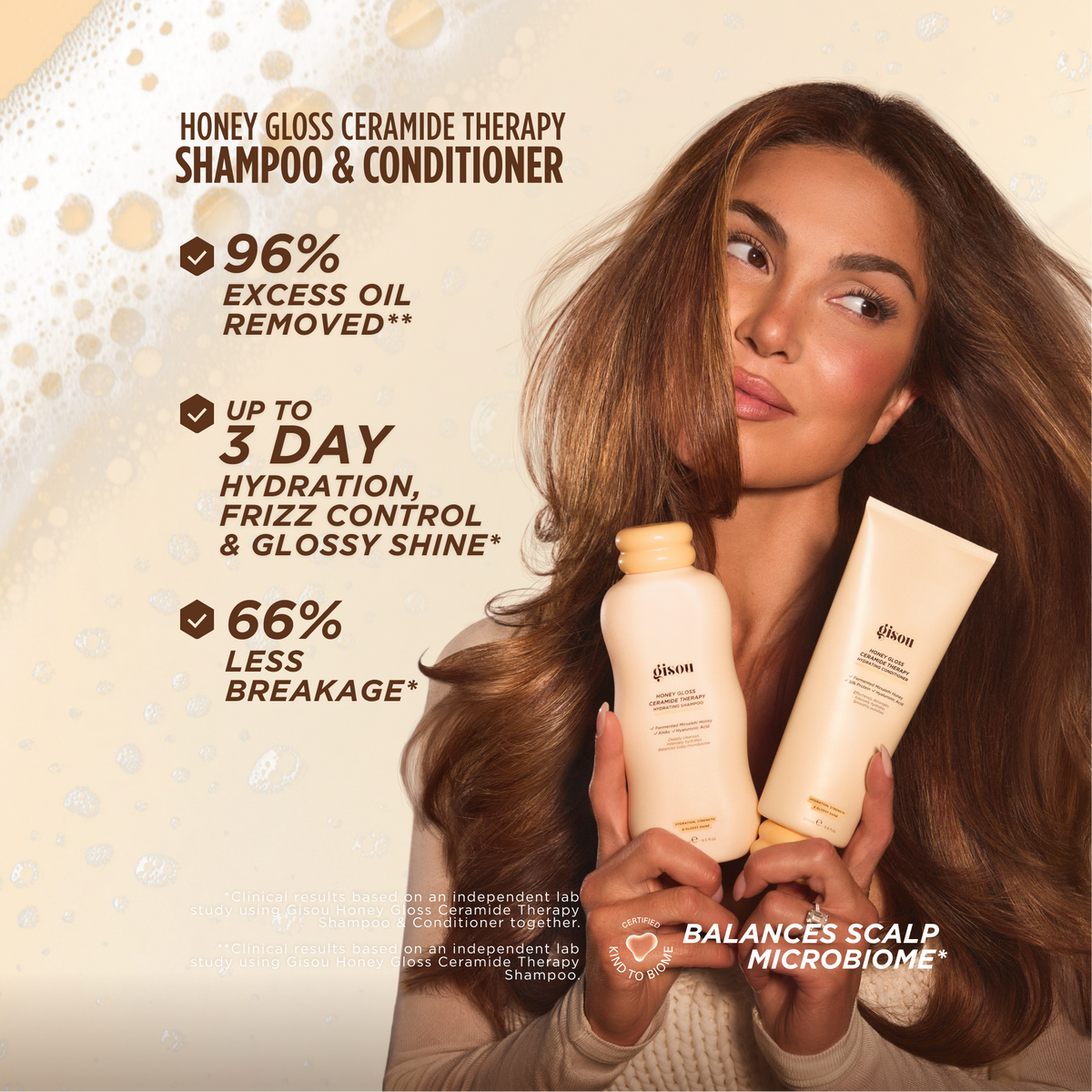 Model with flowing hair holding Gisou Honey Gloss Ceramide Therapy Hydrating Shampoo and Conditioner, listing benefits: 96% excess oil removed, up to 3-day hydration/frizz control/glossy shine, and 66% less breakage.