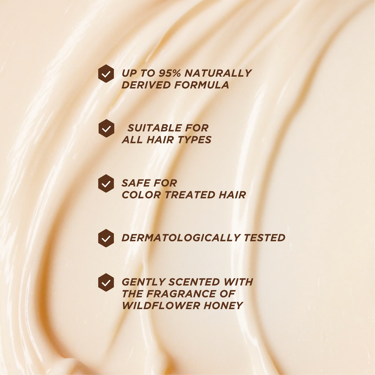 Close-up of a cream hair product texture with formula claims: up to 95% naturally derived, suitable for all hair types, safe for color-treated hair, dermatologically tested, and scented with wildflower honey.