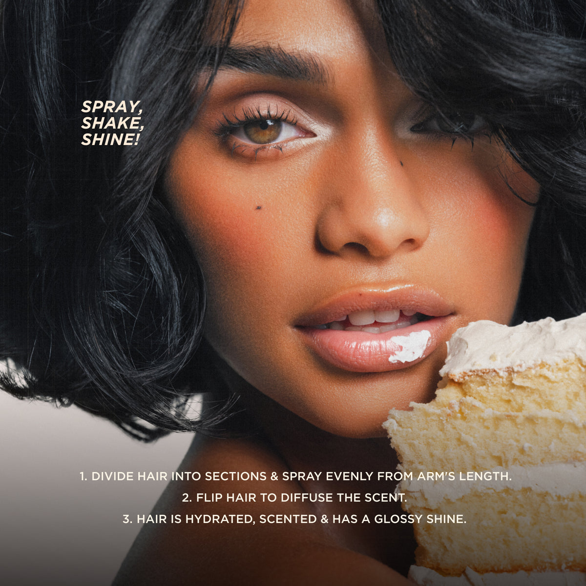 Model with glossy hair and lips holding cake, demonstrating spray application for shine and fragrance.