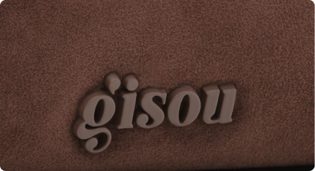 A close-up logo of Gisou on a Choco Suede Pouch.