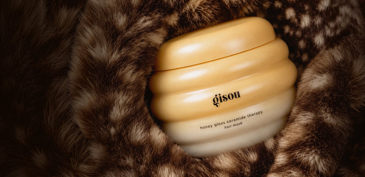 Gisou Honey Gloss Ceramide Therapy Hair Mask jar nestled in Gisou Bambi Pouch.