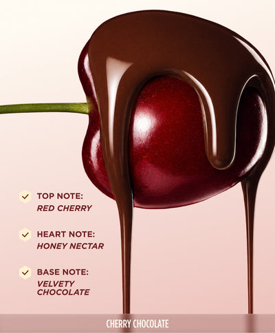 A cherry dipped in dripping dark chocolate, promoting the Gisou Cherry Chocolate Collection.