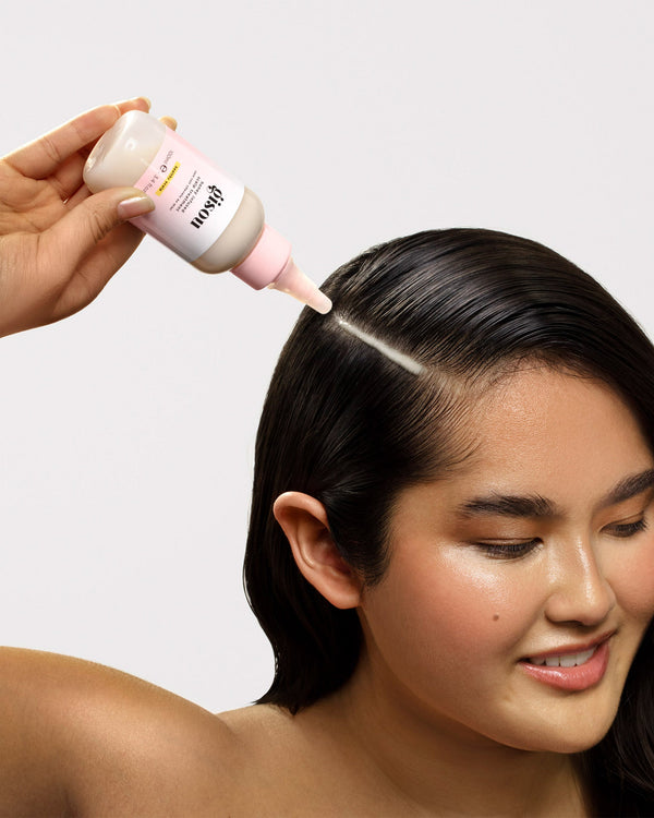 Model applying Honey Infused Scalp Treatment