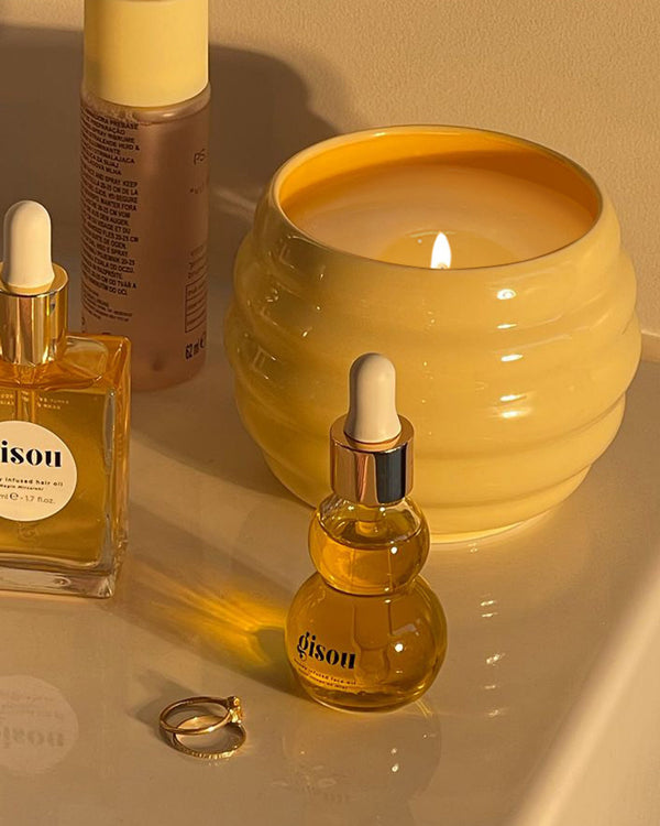 Bathroom image of the Honey Infused Scented Candle and the Face Oil
