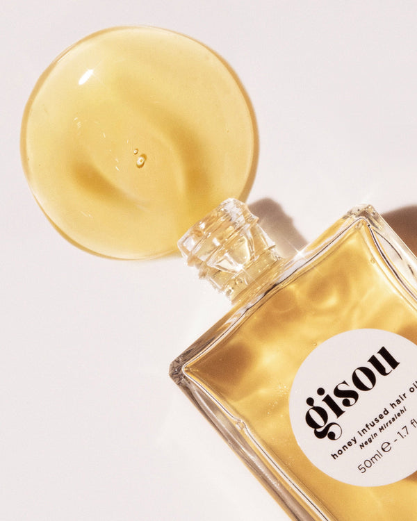 Oil dripping out of the Honey Infused Hair Oil bottle