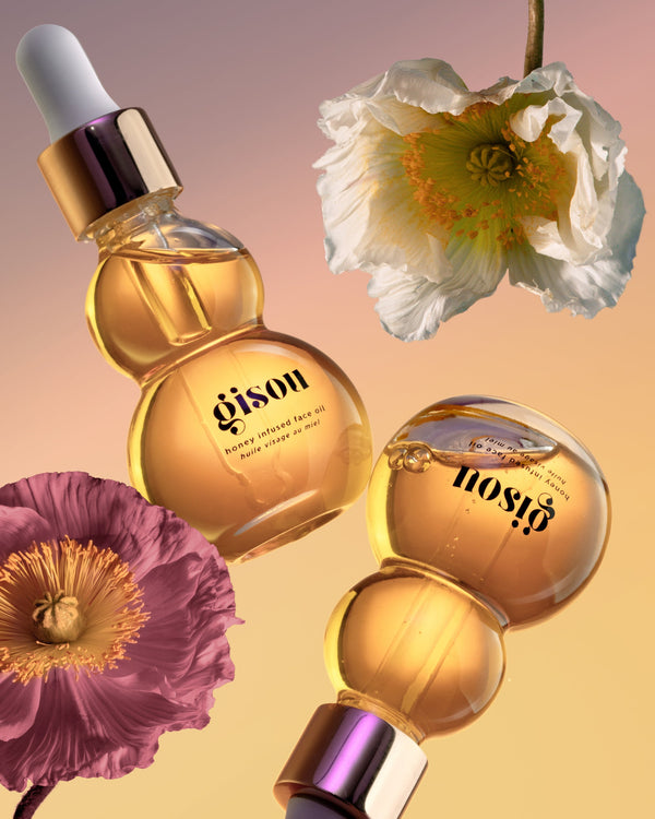 Gisou Founder and models holding a bottle of the Honey Infused Face Oil