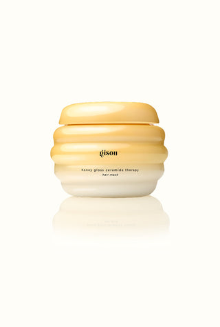 Hair mask in a yellow honeycomb hive jar.