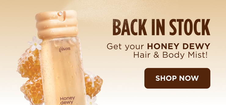 "Back in Stock" ad for Gisou Honey Dewy Honey Infused Hair & Body Mist bottle.