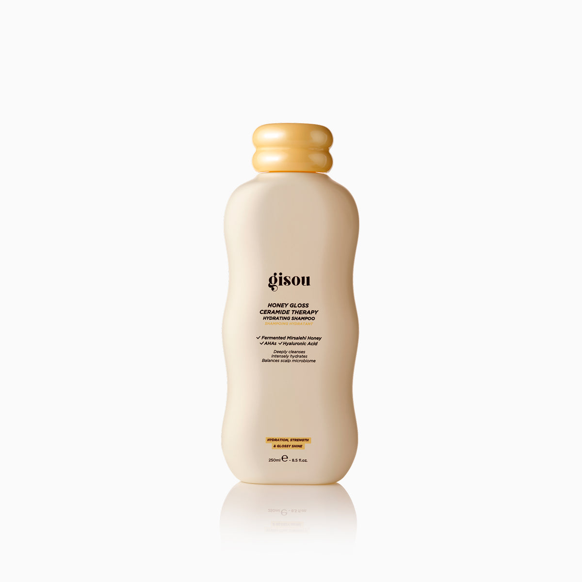 Gisou Honey Gloss Ceramide Therapy Hydrating Shampoo bottle on a clean neutral background.