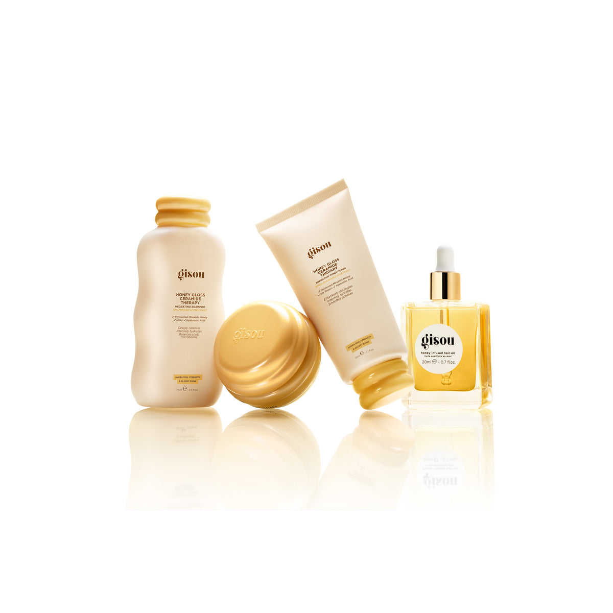 Gisou Honey Gloss Ceramide Therapy routine mini including shampoo 75ml, hair mask 75ml, conditioner 50ml and hair oil 20ml on a white background.