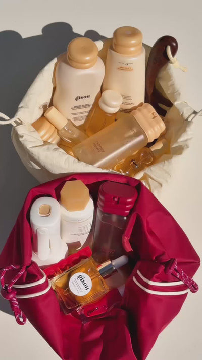 A UGC video of cream and red drawstring pouches filled with Gisou bestselling products.