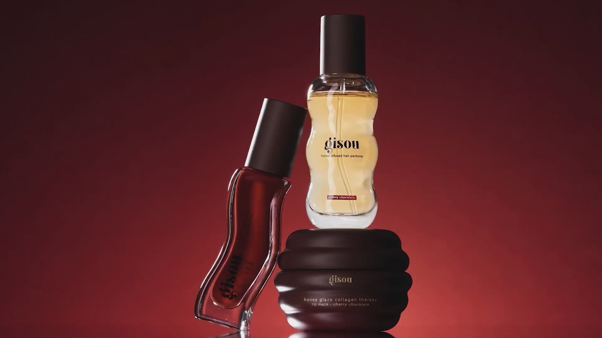 A video showing aesthetics of the new fall Cherry Choco Collection, highlighting the 3 main products: Cherry Chocolate Hair Perfume, Lip Oil, and Lip Mask.