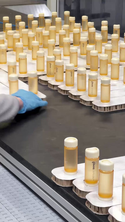 A video from a factory featuring production of Gisou Honey Gloss Collagen Drops.