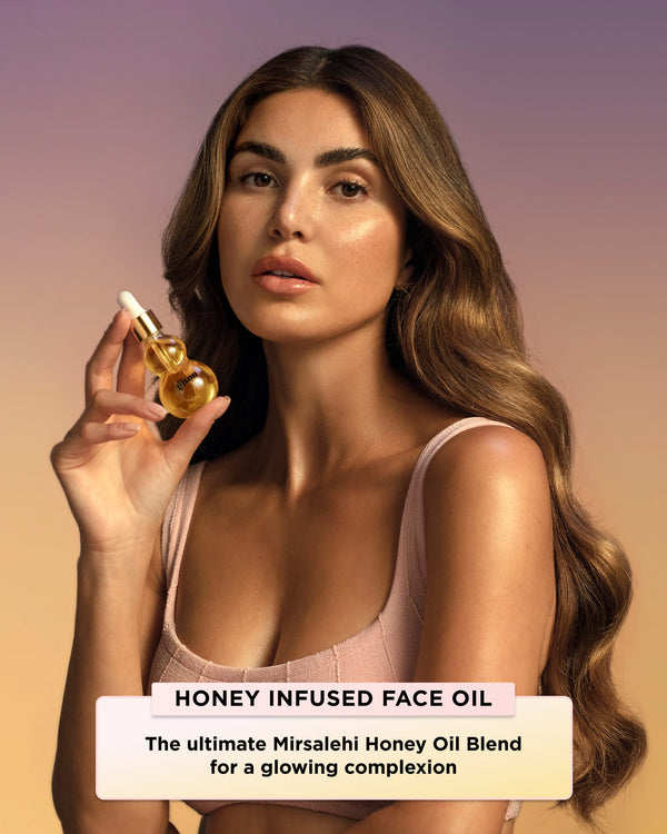 Founder holding a bottle of Honey Infused Face Oil