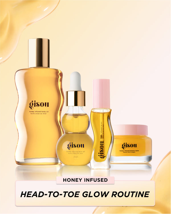 A head-to-toe glow routine consisting of bottle of body oil, a bottle of face oil, a bottle of lip oil, and a jar of the beauty balm on the yellow background 